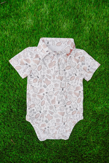 Baby onesie with football pattern on grass