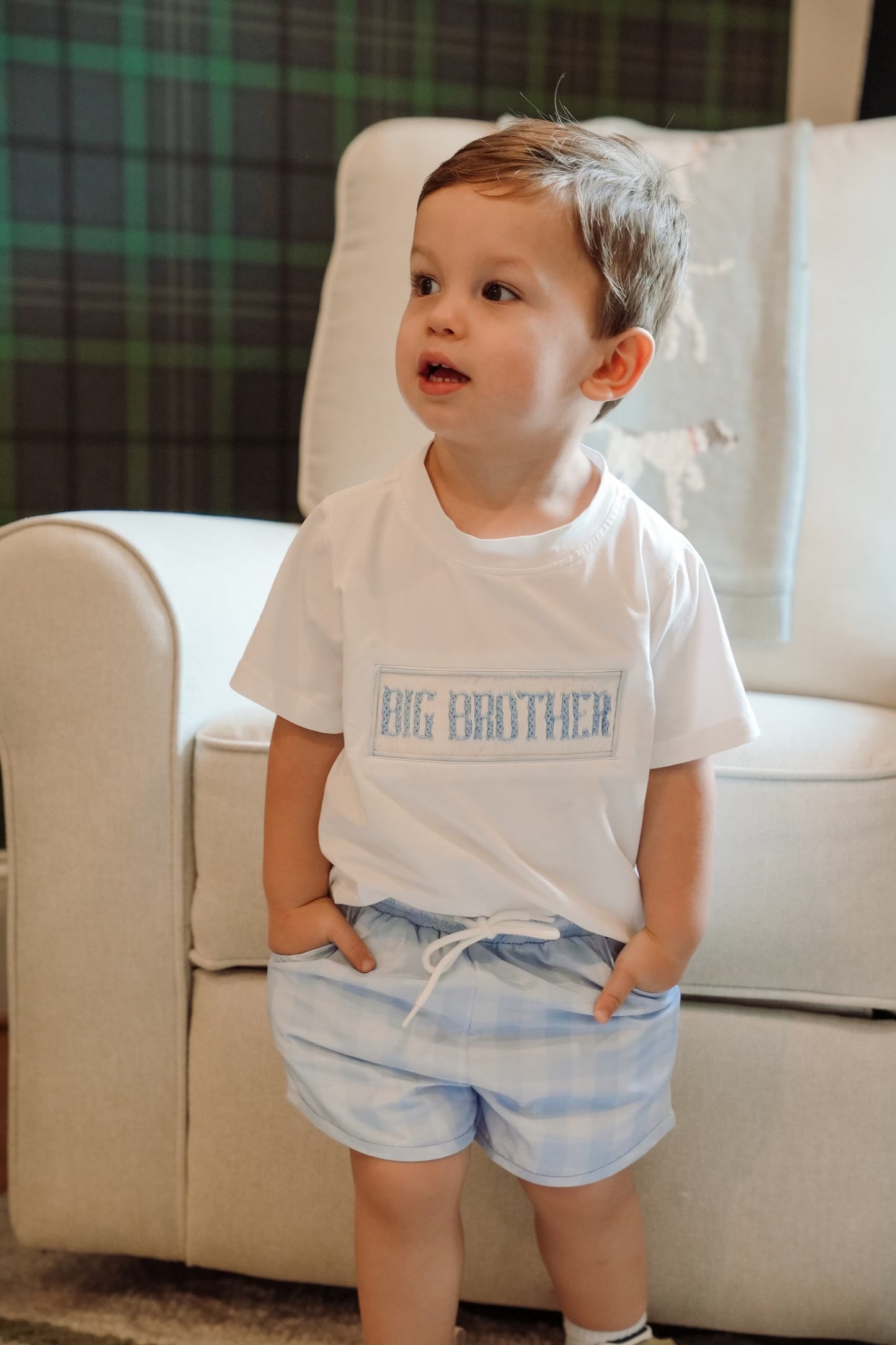 Toddler boy wearing a Big Brother embroidered shirt with blue plaid shorts, perfect for sibling photos, baby announcements, and welcoming a new baby