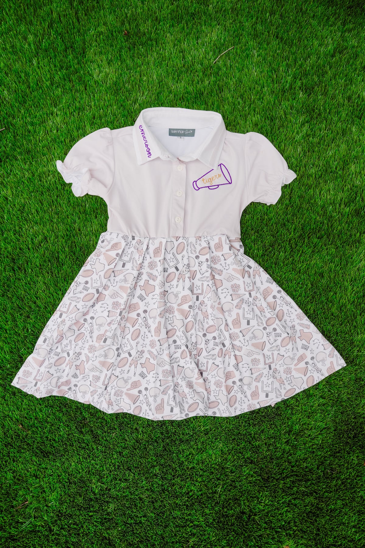 White dress with gameday pattern on a grass background