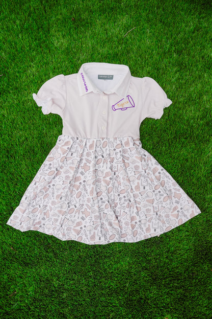 White dress with gameday pattern on a grass background