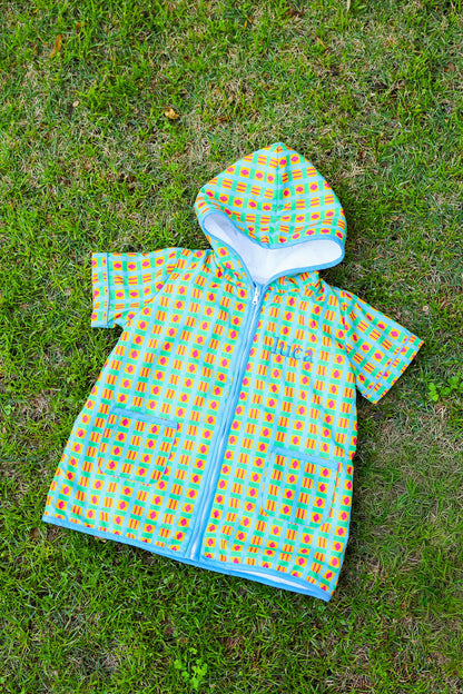 Retro Splash kids hooded towel poncho with a colorful geometric print and front zipper