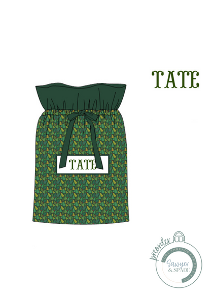 Green patterned dress with 'TATE' branding on a white background